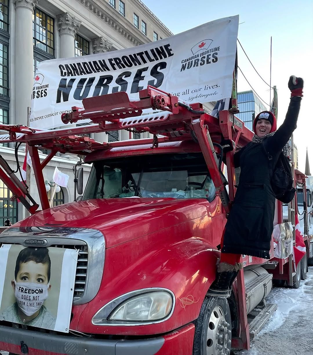 Sarah Choujounian hanging from the Canadian Frontline Nurses truck in Ottawa